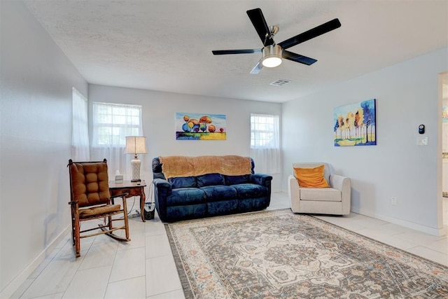 living area with visible vents, a wealth of natural light, and light tile patterned flooring