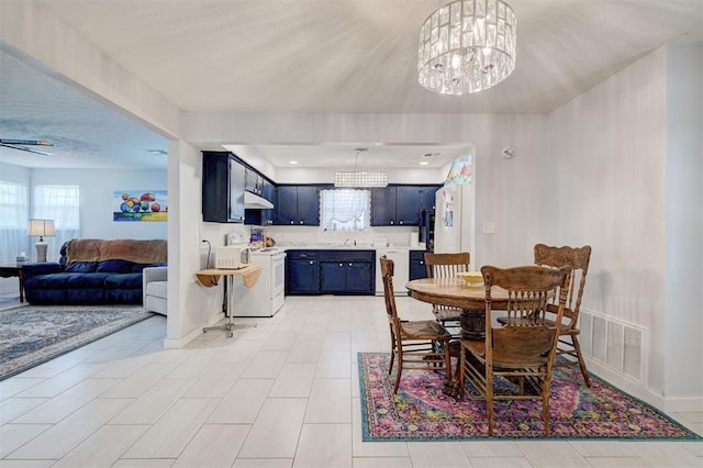 dining room with baseboards, visible vents, and a chandelier