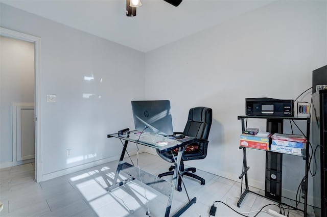 home office featuring baseboards and a ceiling fan