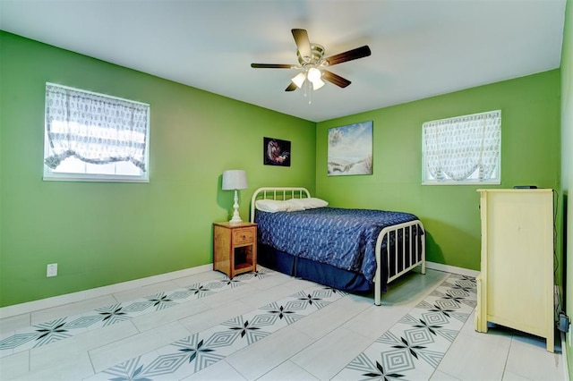 bedroom featuring tile patterned flooring, a ceiling fan, and baseboards