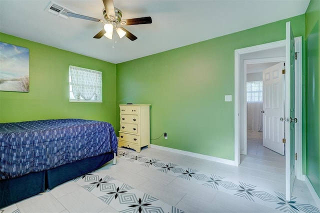 bedroom featuring ceiling fan, baseboards, light tile patterned flooring, and visible vents