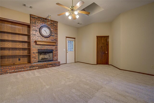 unfurnished living room with a ceiling fan, visible vents, carpet flooring, and a brick fireplace