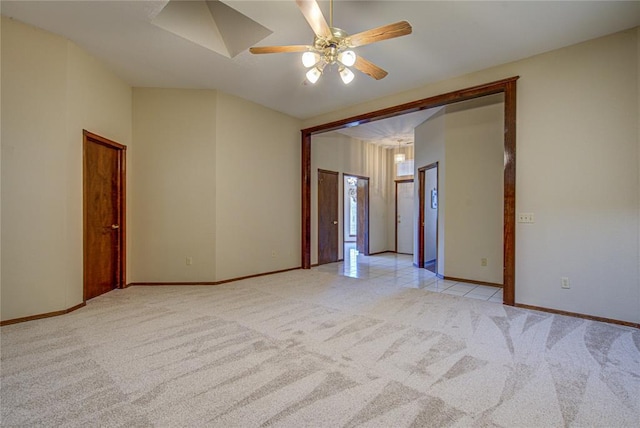 empty room featuring ceiling fan, light carpet, and baseboards