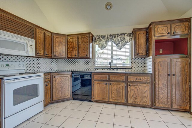 kitchen with decorative backsplash, vaulted ceiling, white appliances, and a sink