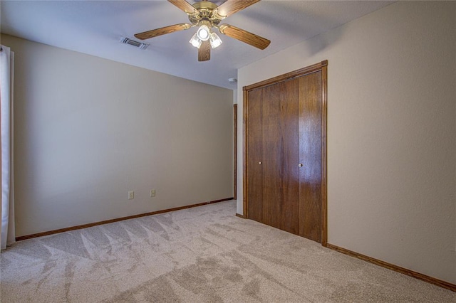 unfurnished bedroom with baseboards, visible vents, a closet, ceiling fan, and carpet floors