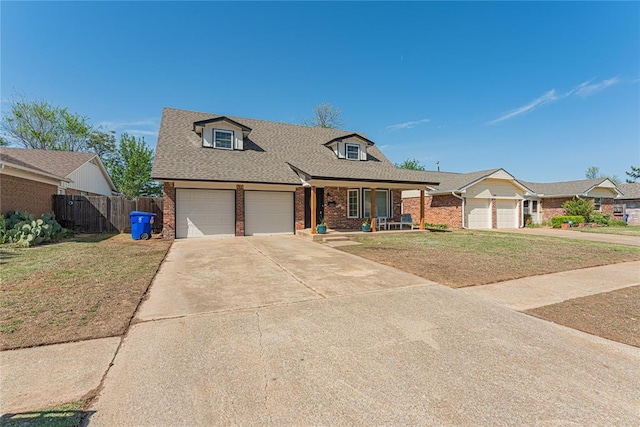 view of front of house with a front lawn, brick siding, a porch, and fence