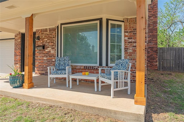 view of patio with fence and covered porch