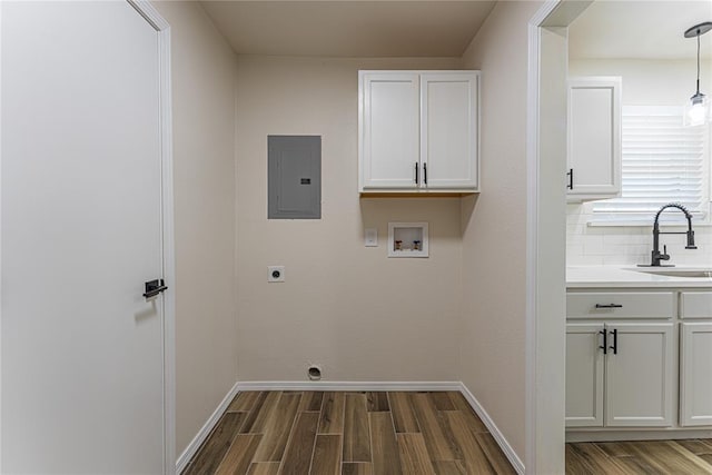 laundry area with electric panel, dark wood-style floors, a sink, hookup for an electric dryer, and washer hookup