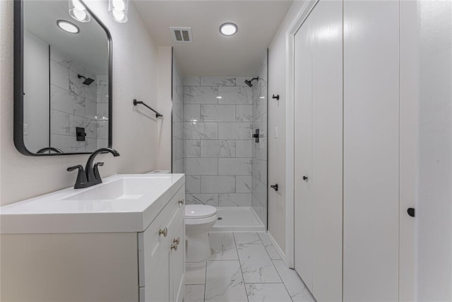 bathroom with marble finish floor, visible vents, toilet, vanity, and a stall shower