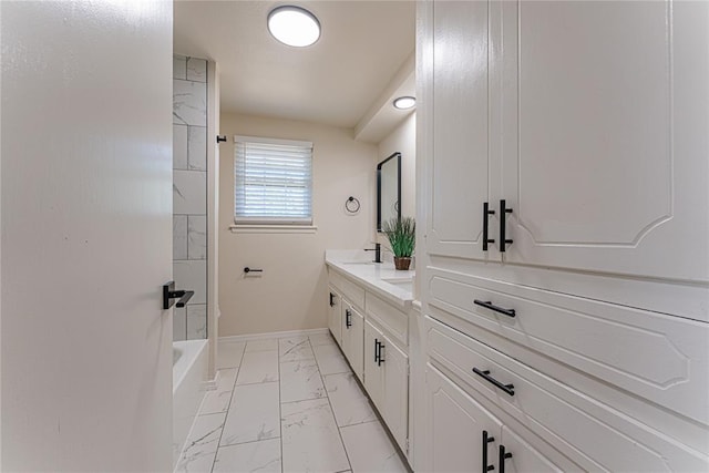 full bathroom featuring a sink,  shower combination, marble finish floor, double vanity, and baseboards