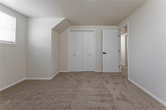 unfurnished bedroom featuring baseboards, a closet, and carpet