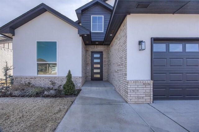 property entrance with stucco siding and brick siding