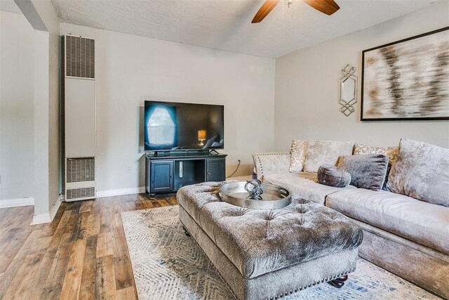 1115 W Eufaula St, Norman, OK 73069 - living area featuring baseboards, a ceiling fan, wood finished floors, and a heating unit