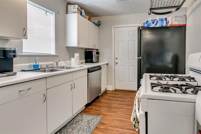 1115 W Eufaula St, Norman, OK 73069 - kitchen featuring a sink, freestanding refrigerator, white gas stove, dishwasher, and light countertops