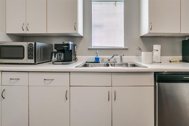 1115 W Eufaula St, Norman, OK 73069 - kitchen with light countertops, a sink, white cabinetry, and appliances with stainless steel finishes