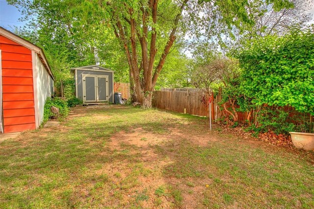 1115 W Eufaula St, Norman, OK 73069 - view of yard with a fenced backyard, an outdoor structure, and a shed