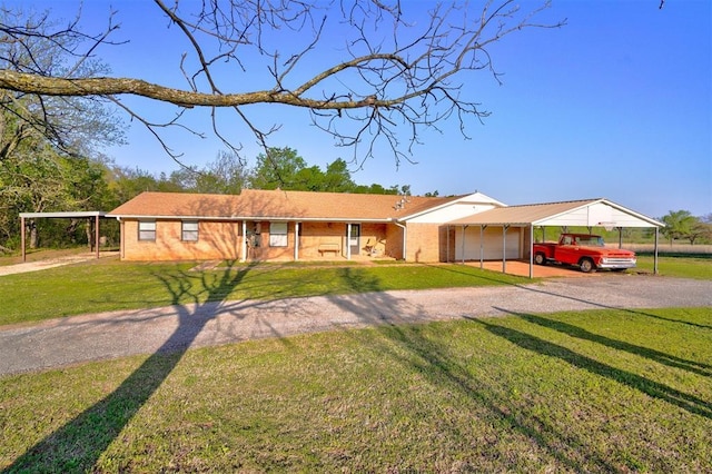 single story home featuring driveway, a front yard, and a garage