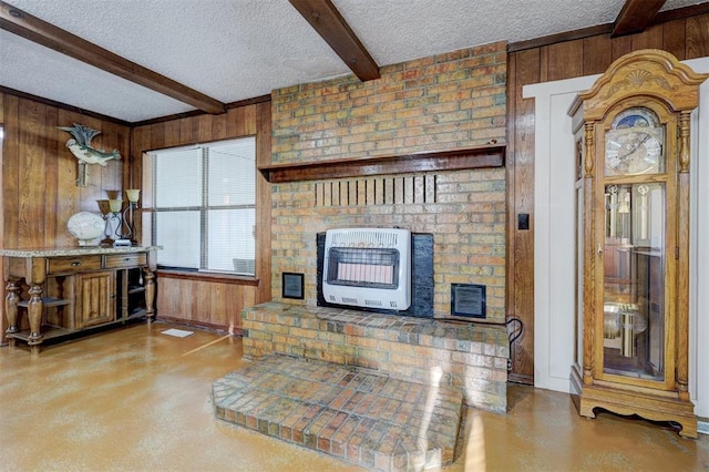 living area with heating unit, a textured ceiling, concrete flooring, wooden walls, and beam ceiling