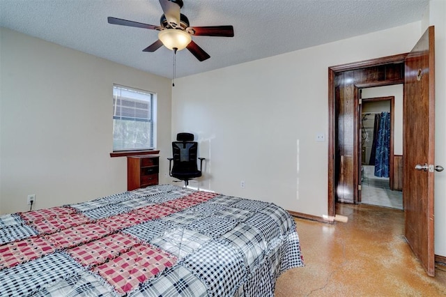 bedroom featuring ceiling fan, baseboards, and a textured ceiling