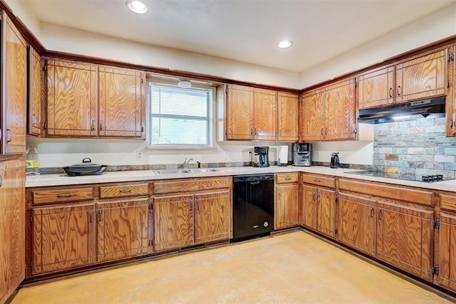 kitchen with brown cabinetry, under cabinet range hood, a sink, and black appliances