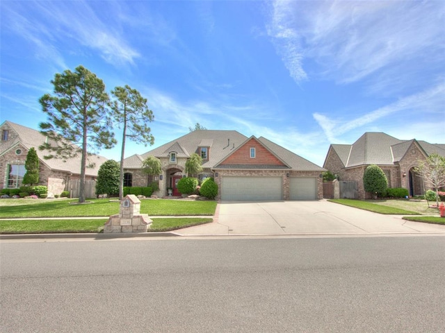 3116 Sycamore Dr, Moore, OK 73160 - view of front facade with driveway, stone siding, a front yard, an attached garage, and brick siding