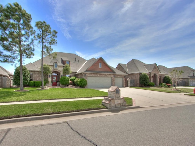 3116 Sycamore Dr, Moore, OK 73160 - view of front of home featuring driveway, stone siding, an attached garage, brick siding, and a front lawn