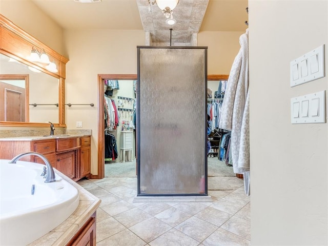 3116 Sycamore Dr, Moore, OK 73160 - full bathroom with a bath, a walk in closet, a shower stall, and vanity