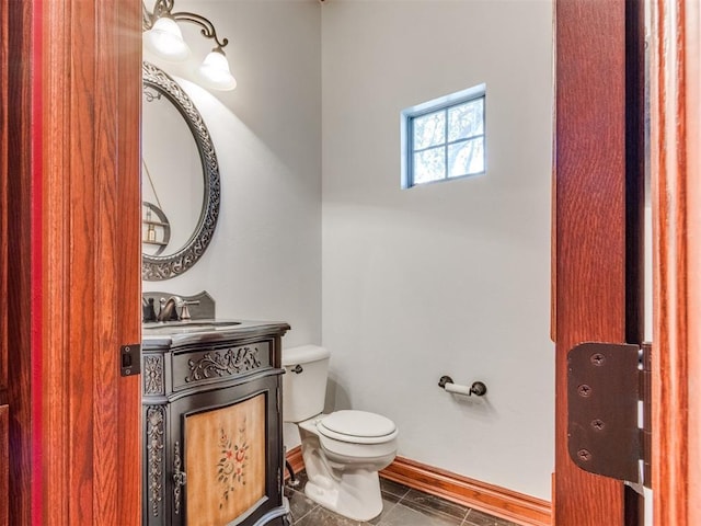 3116 Sycamore Dr, Moore, OK 73160 - bathroom with tile patterned floors, baseboards, toilet, and vanity