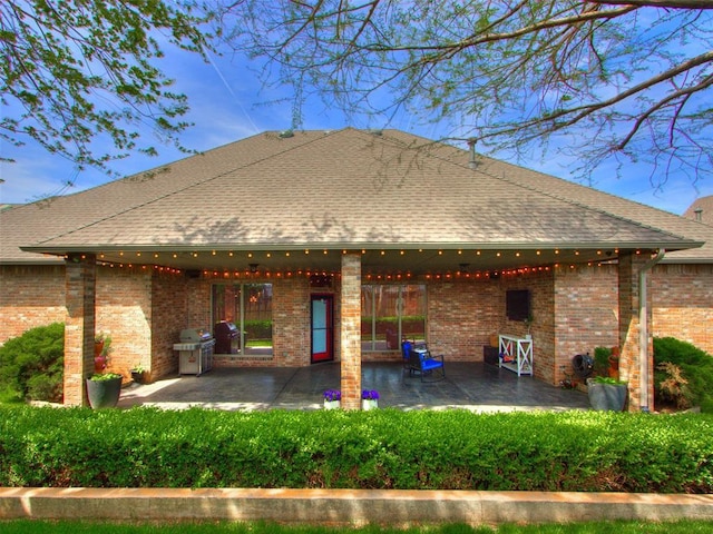 3116 Sycamore Dr, Moore, OK 73160 - back of house with a patio, roof with shingles, and brick siding