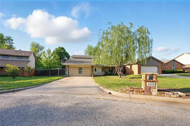 5029 NW 24th Pl, Oklahoma City, OK 73127 - ranch-style house featuring fence, driveway, board and batten siding, and a front yard