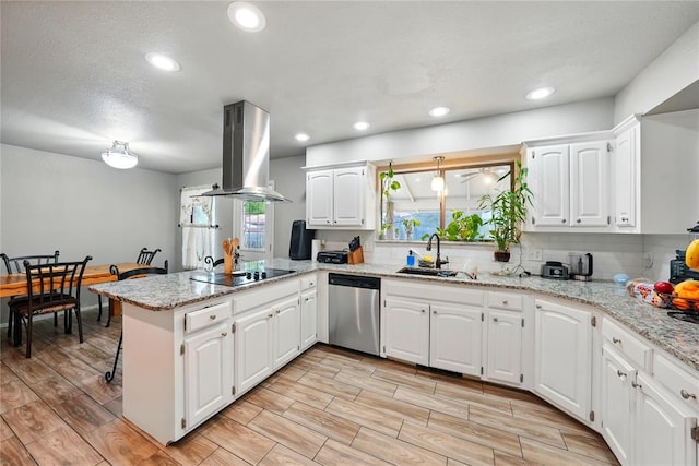 5029 NW 24th Pl, Oklahoma City, OK 73127 - kitchen with stainless steel dishwasher, a sink, island exhaust hood, black electric stovetop, and a peninsula