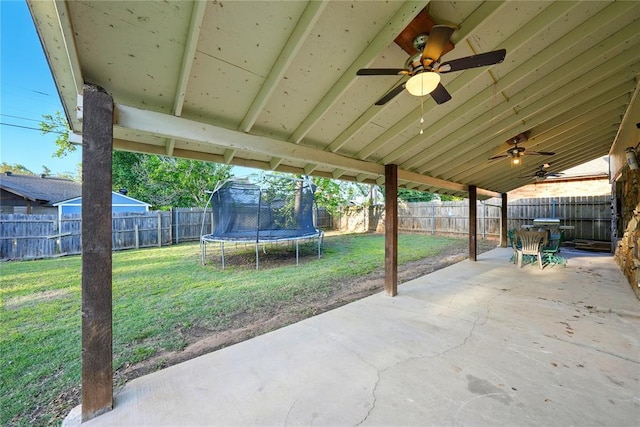 5029 NW 24th Pl, Oklahoma City, OK 73127 - view of patio featuring a fenced backyard, a ceiling fan, and a trampoline