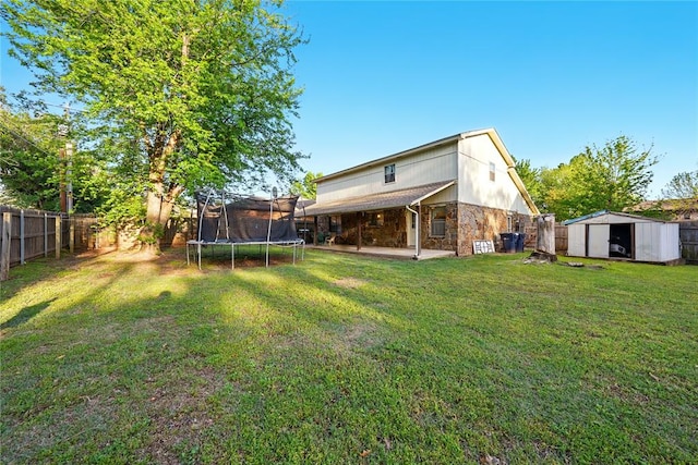 5029 NW 24th Pl, Oklahoma City, OK 73127 - view of yard featuring a fenced backyard, a storage shed, a patio area, an outbuilding, and a trampoline