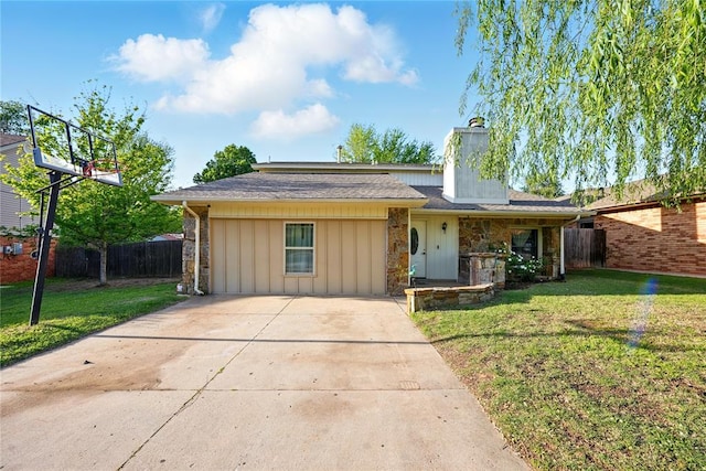 5029 NW 24th Pl, Oklahoma City, OK 73127 - ranch-style house featuring a chimney, a front lawn, concrete driveway, board and batten siding, and fence