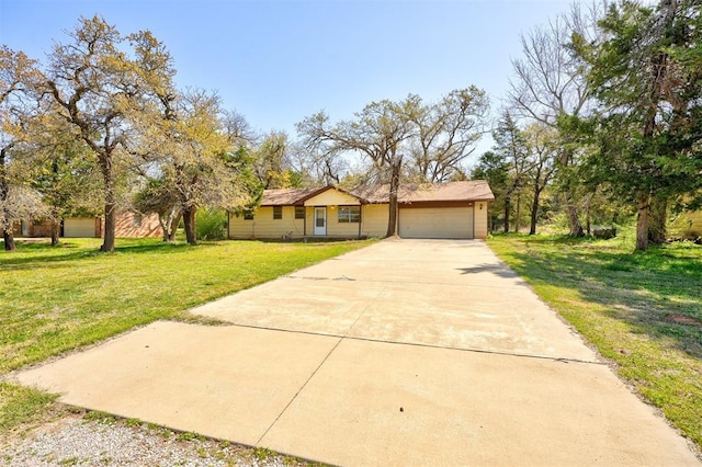 ranch-style house featuring an attached garage, driveway, and a front lawn