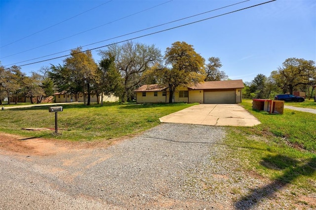 ranch-style home featuring an attached garage, driveway, and a front lawn