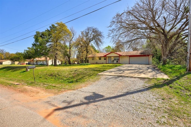 ranch-style house with a front lawn, dirt driveway, and a garage