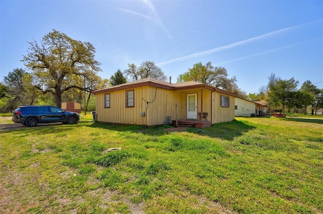 view of side of home featuring a yard