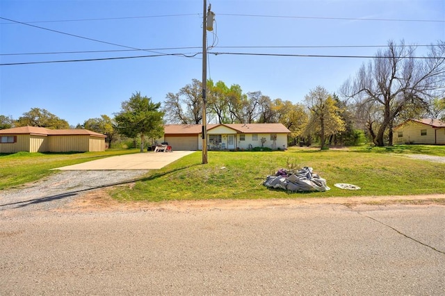 single story home with a garage, driveway, and a front yard