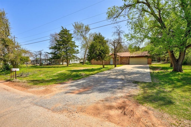 obstructed view of property with driveway and a front yard