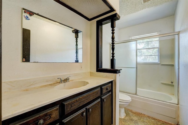 bathroom featuring combined bath / shower with glass door, toilet, and vanity