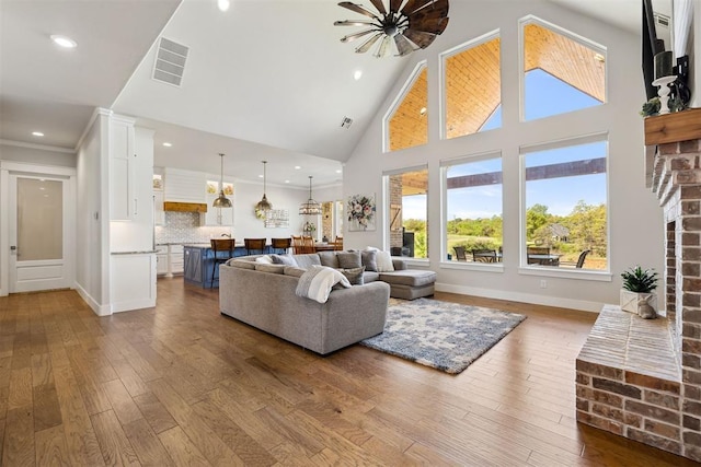 living room with dark wood-style flooring, plenty of natural light, and visible vents