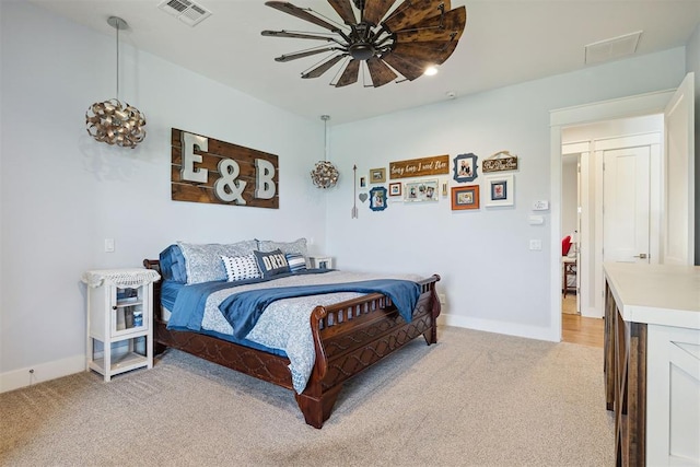 bedroom featuring baseboards, visible vents, and light colored carpet