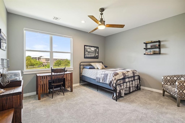 carpeted bedroom with baseboards, visible vents, and a ceiling fan