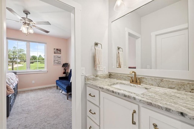 ensuite bathroom with vanity, baseboards, connected bathroom, and ceiling fan