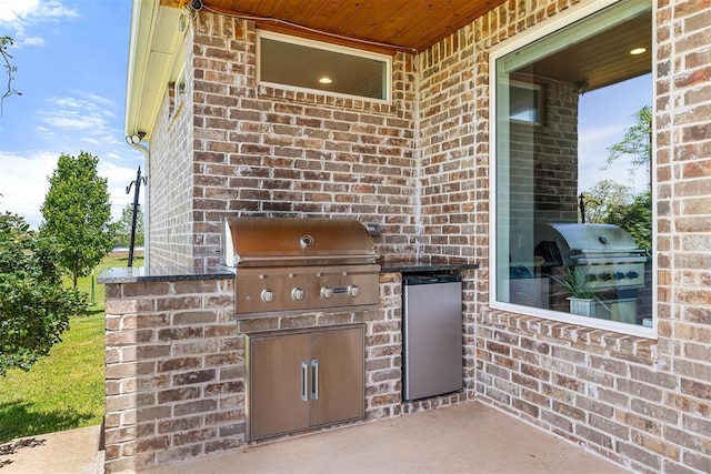 view of patio featuring exterior kitchen and grilling area