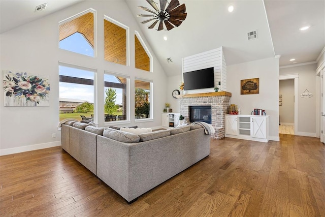 living area featuring hardwood / wood-style floors, visible vents, and plenty of natural light