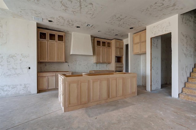 3825 Stone Hill Ln, Edmond, OK 73034 - kitchen with wall chimney exhaust hood, a center island, visible vents, and light brown cabinetry