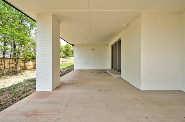 3825 Stone Hill Ln, Edmond, OK 73034 - view of patio with fence and a carport
