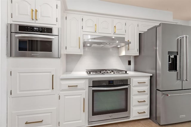 12600 Green Valley Dr, Oklahoma City, OK 73120 - kitchen featuring stainless steel appliances, range hood, and white cabinetry
